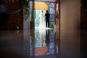 千里阪急ホテルにてチャペルの入り口に立って見つめあう新郎新婦